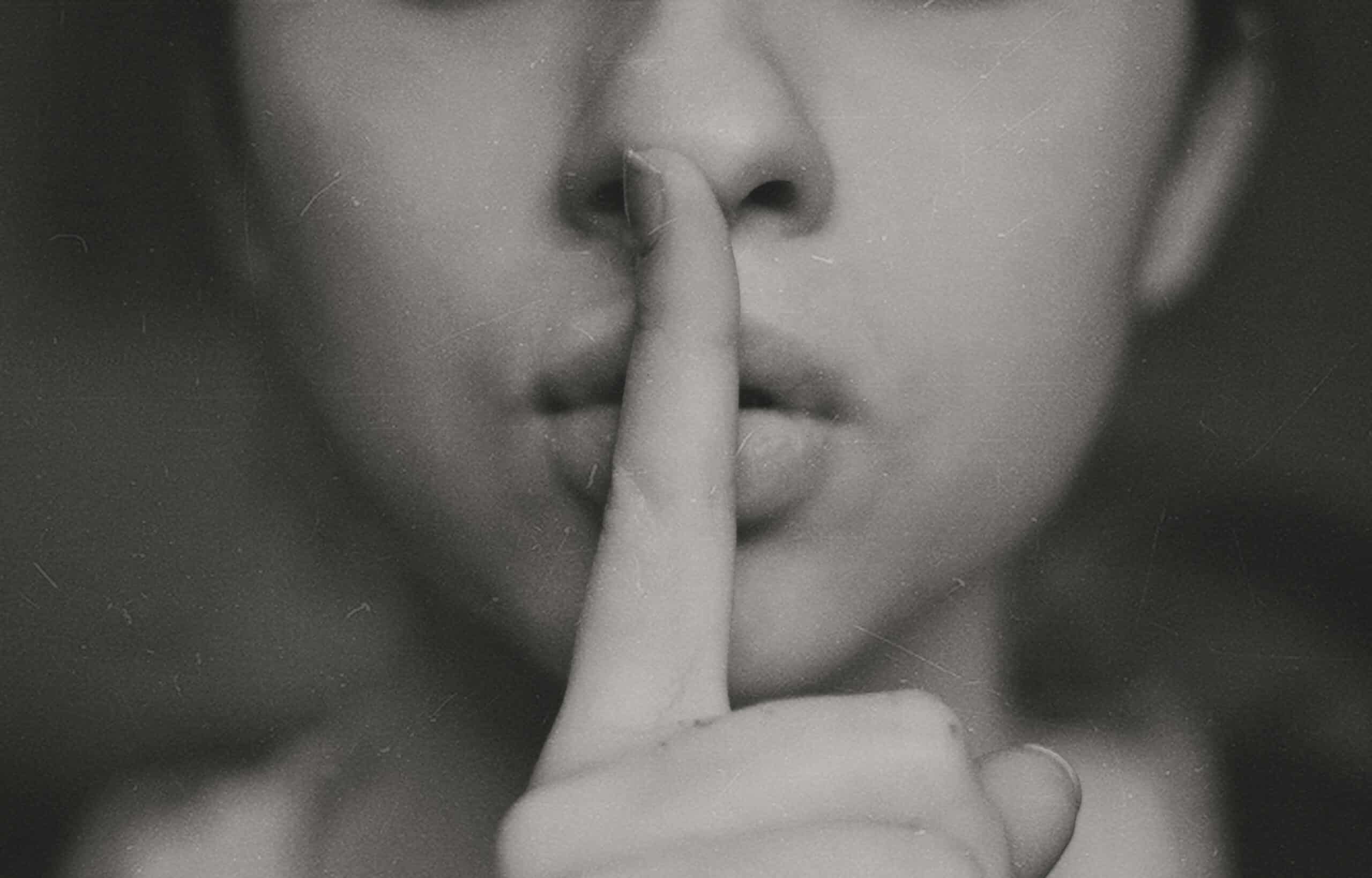Secrecy shown by finger to lips